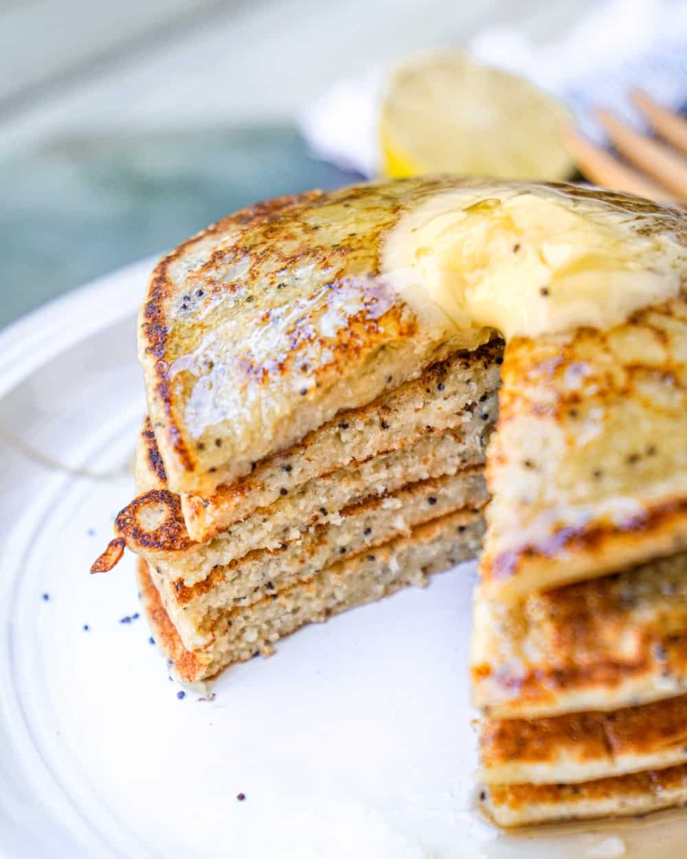 Gluten-Free Lemon Poppyseed Pancakes Stacked with Syrup and Butter Close Up