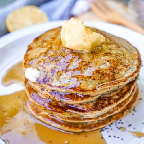 Vegan Lemon Poppyseed Pancakes Stacked with Syrup and Butter