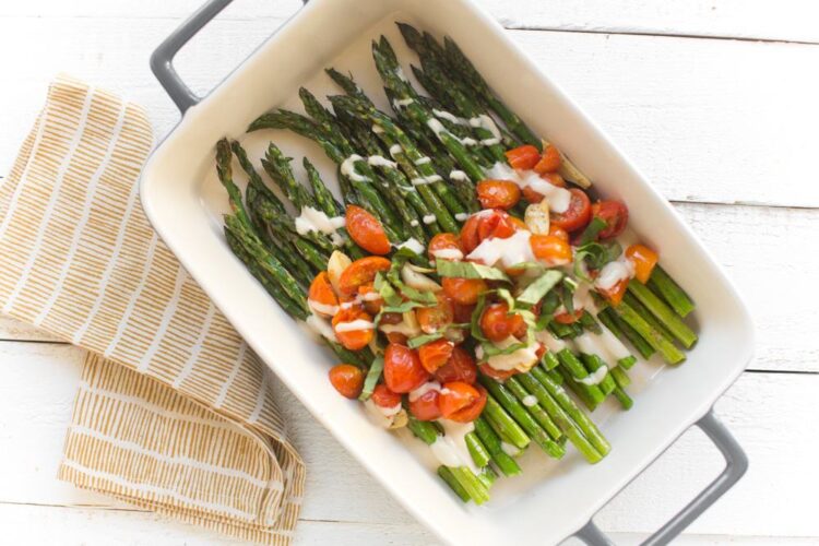Sheet Pan Roasted Asparagus With Garlic, Tomatoes, and a Tahini Drizzle