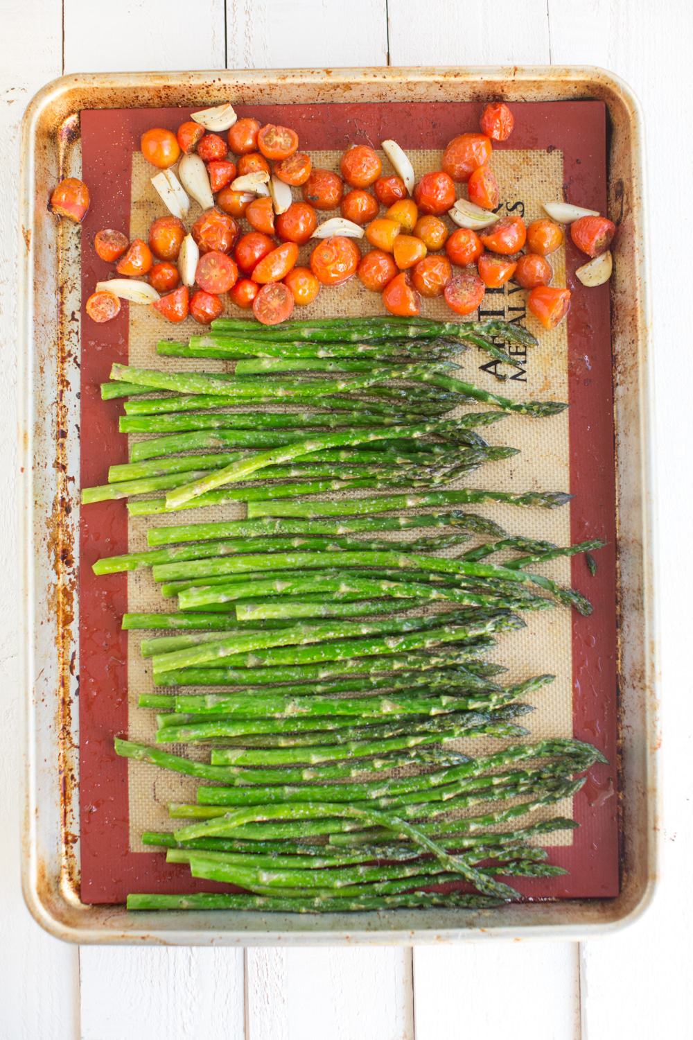 Sheet Pan Roasted Asparagus With Garlic, Tomatoes, and Tahini Dressing