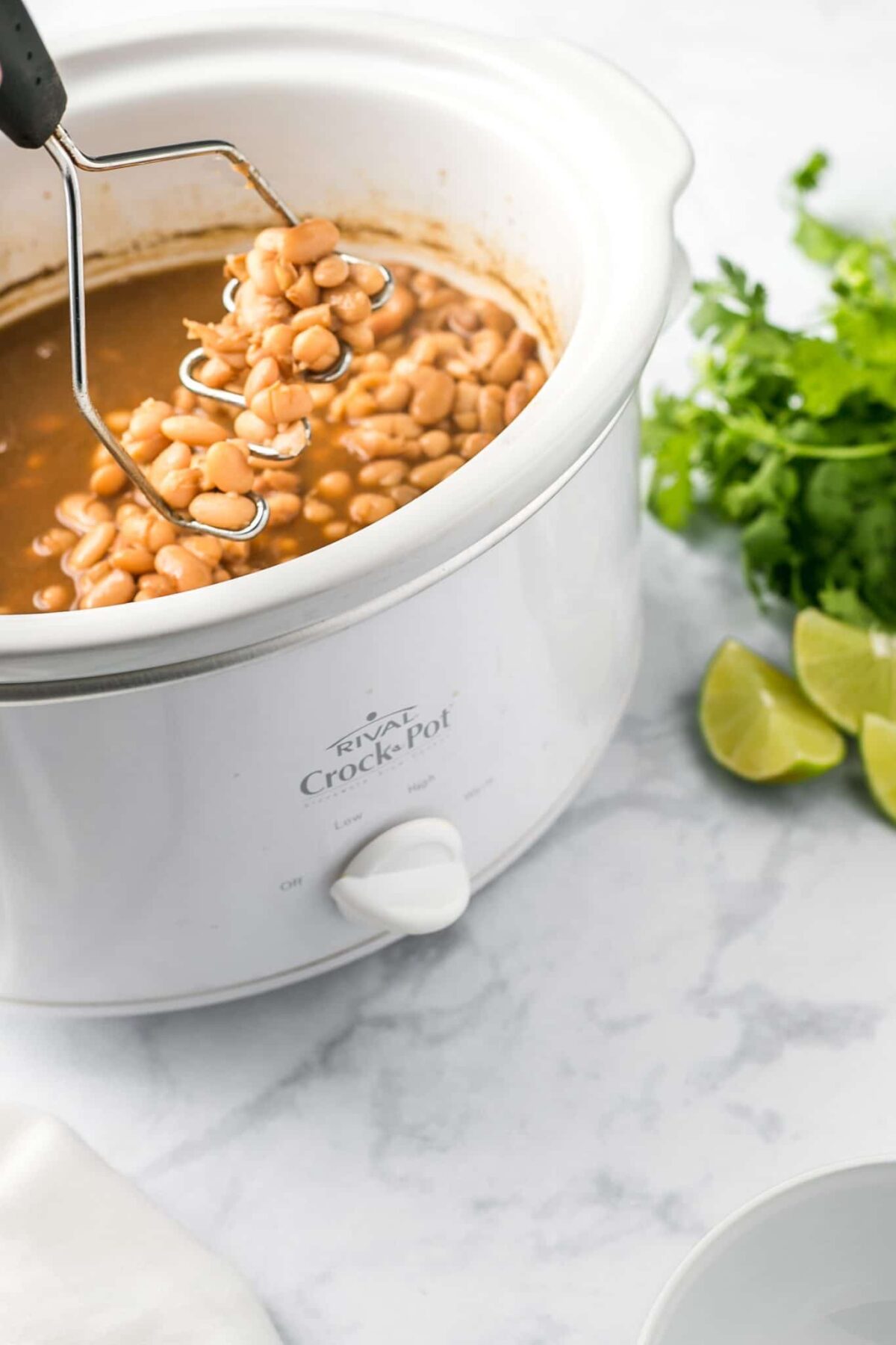 A crockpot with refried beans.