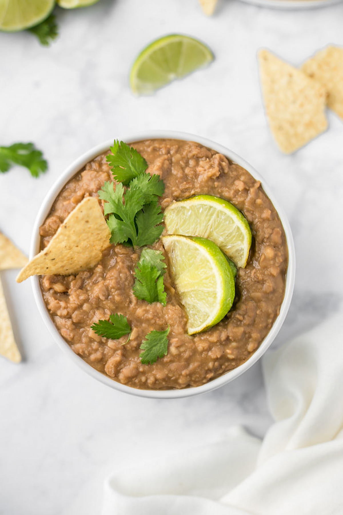 Vegan refried beans in a bowl with chips.