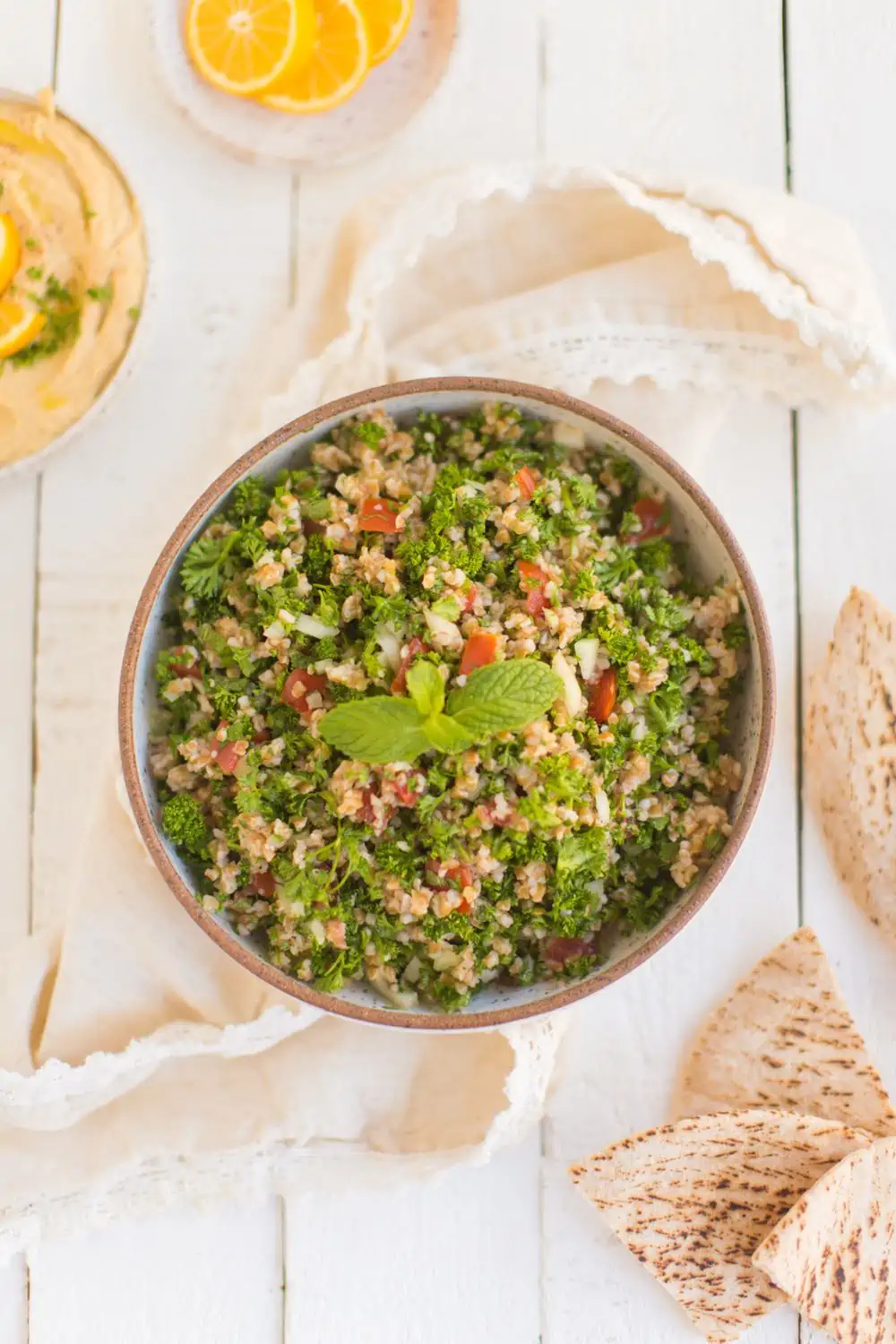 Easy Tabbouleh Salad Recipe Served With a Side of Hummus, Pita, and Lemon Slices