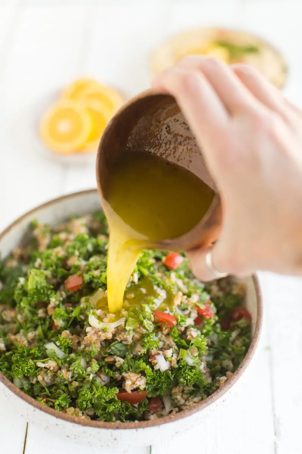 Tabbouleh Dressing Pouring into the Salad