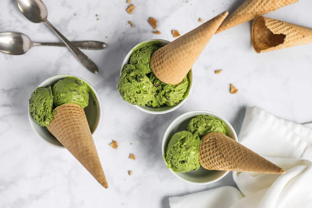matcha ice cream with cones face-down in porcelain glasses