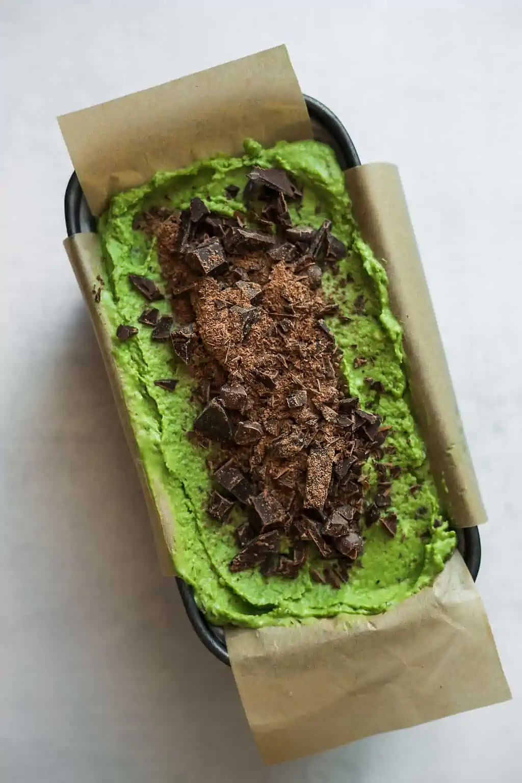 Dairy-Free Matcha Chip Ice Cream Recipe in a container topped with vegan chocolate chips.