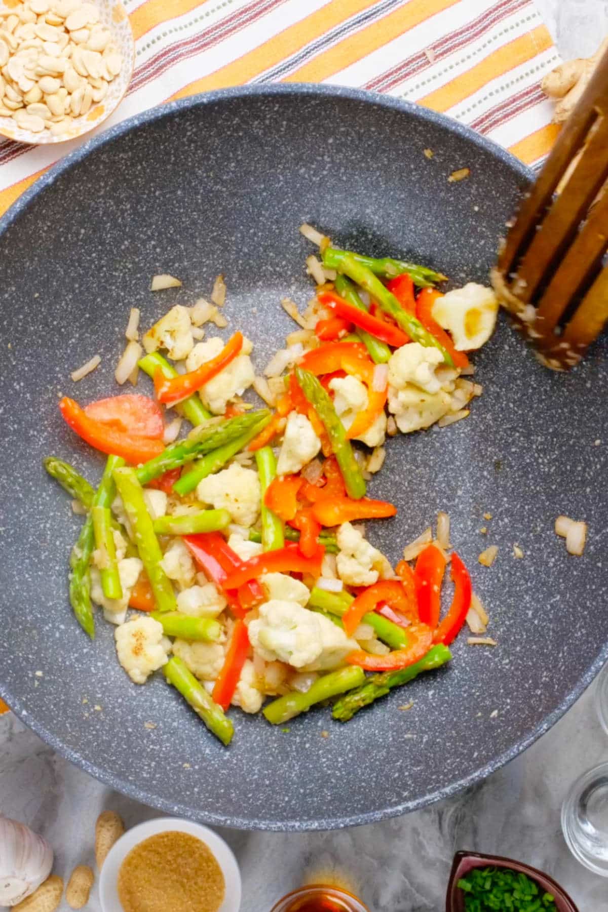 Mixed vegetables cooking in a nonstick pan.