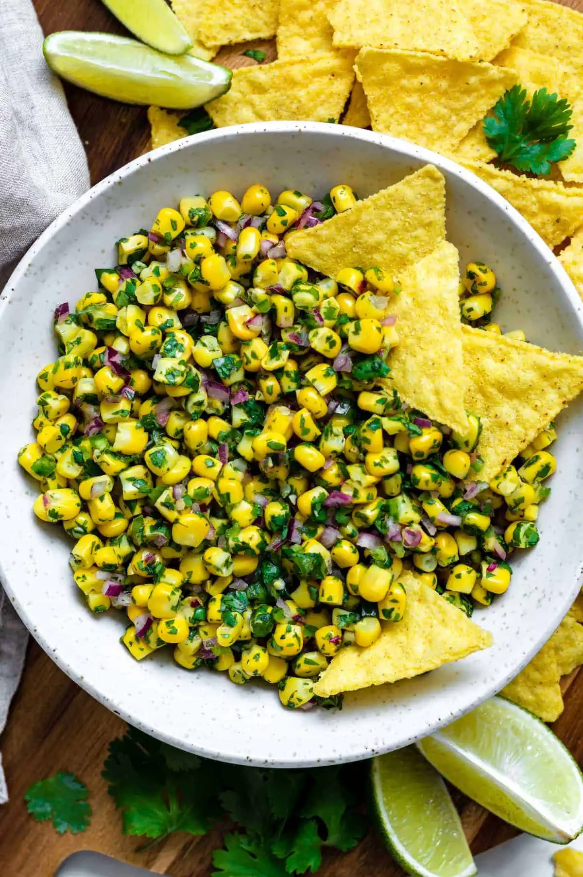 Roasted chili corn salsa in a bowl with tortilla chips.