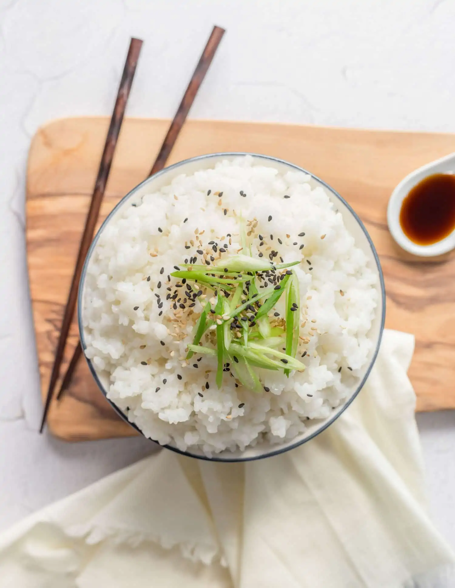 Steamed Sticky White Rice in a bowl with chopsticks.