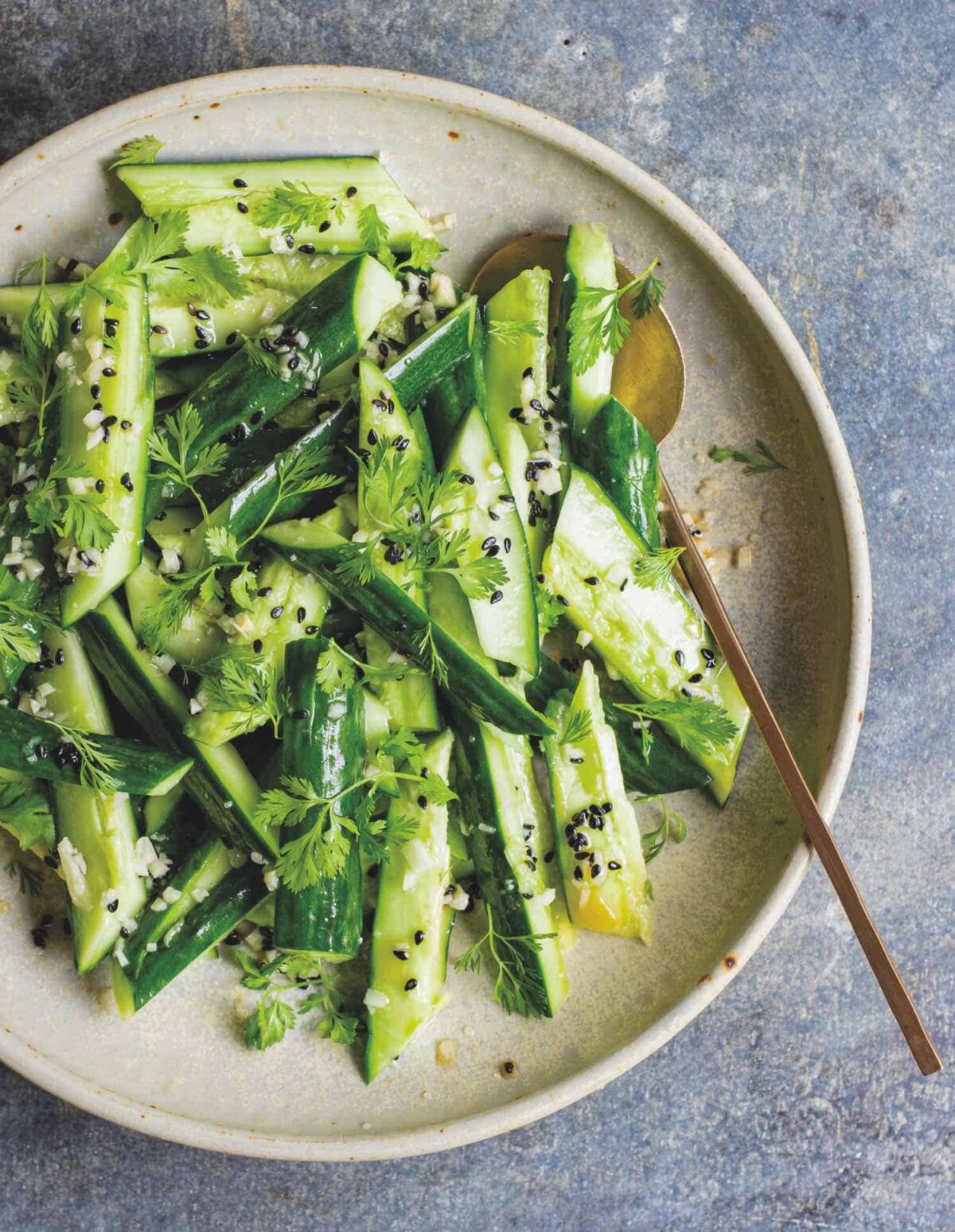 A smashed cucumber salad with fresh herbs, a refreshing complement to vegan picnic ideas.