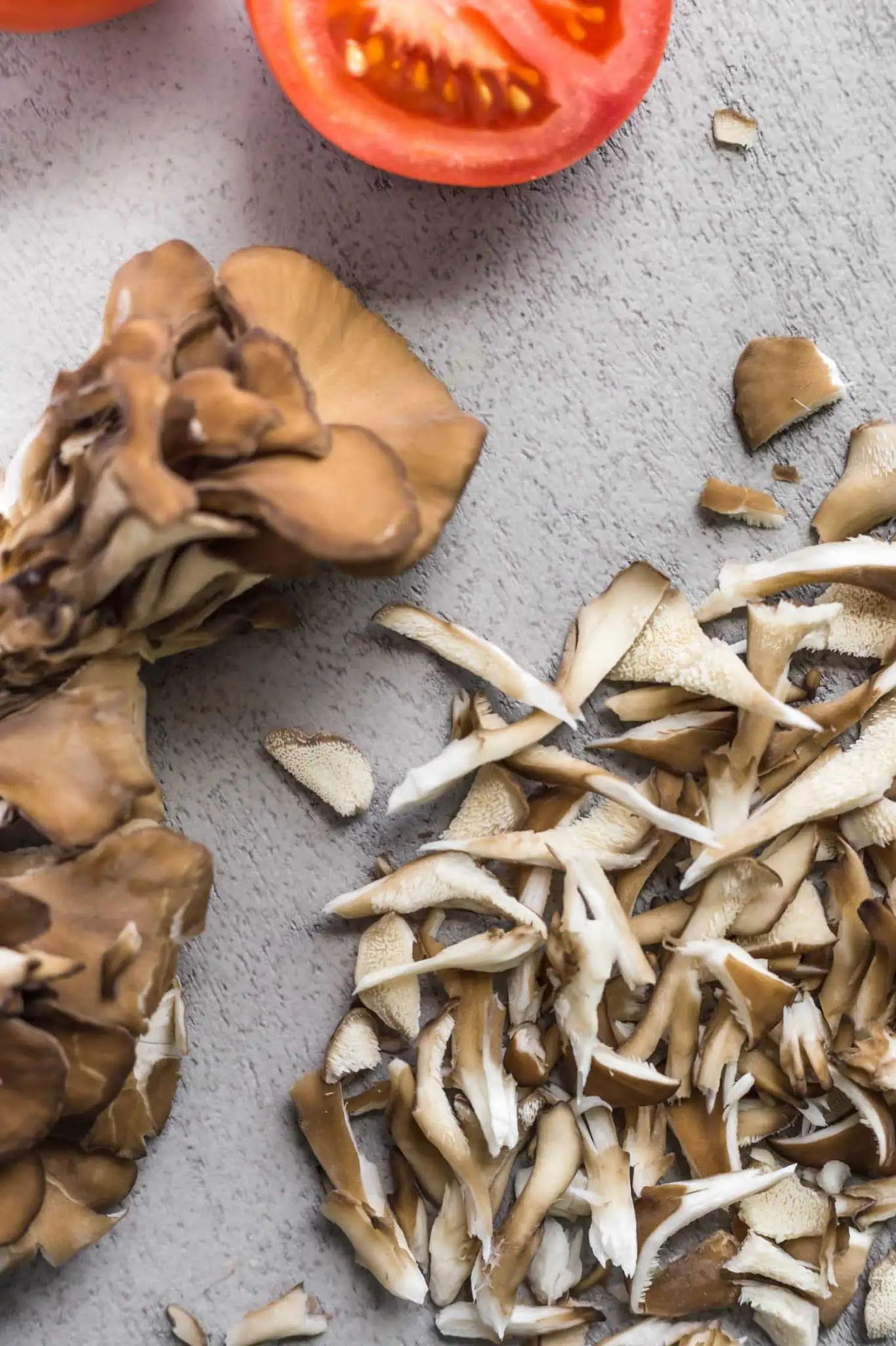 Chopped and shredded oyster mushrooms for tacos with chunks of fresh tomato on the side.