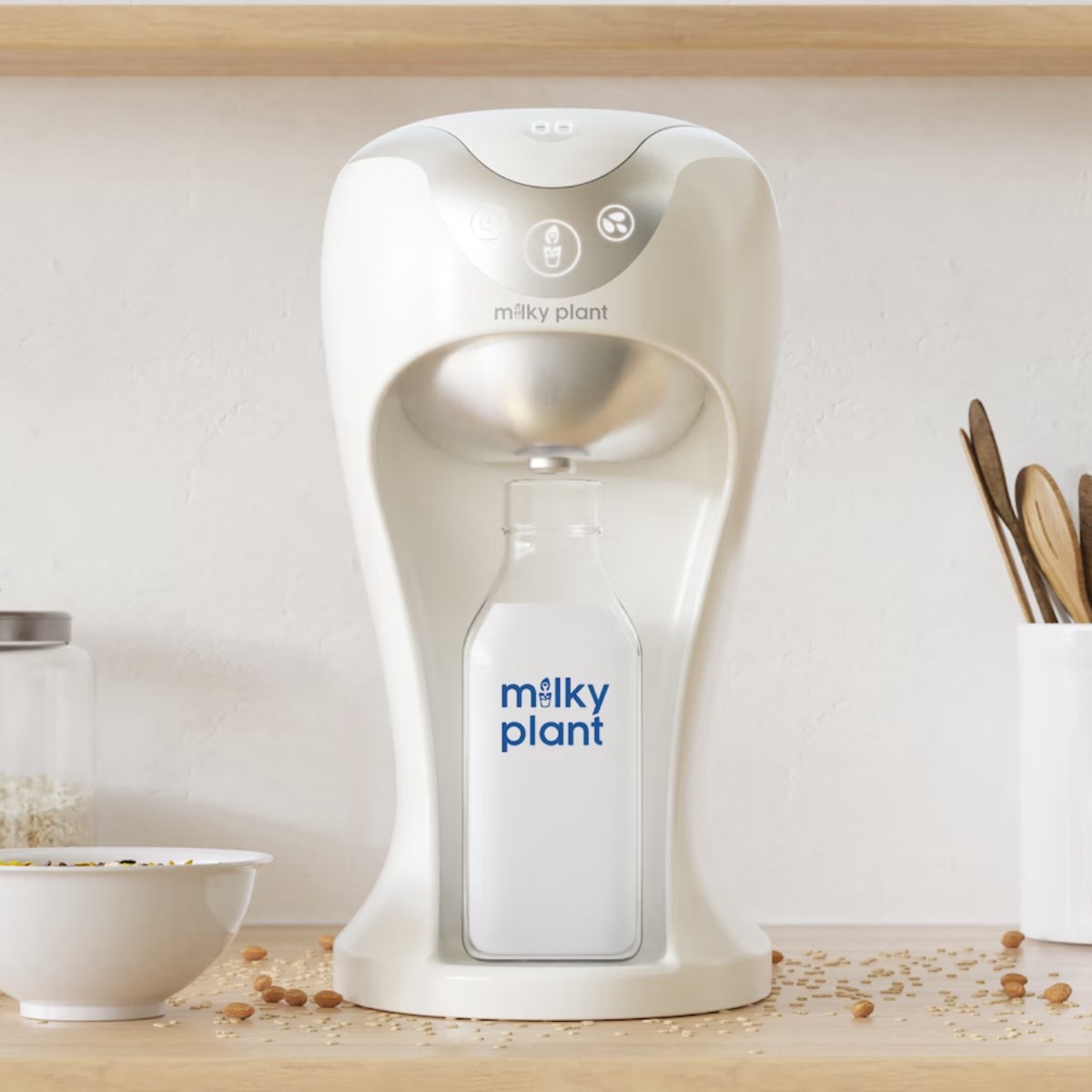 The white Milky Plant nut milk maker machine on a kitchen counter. 