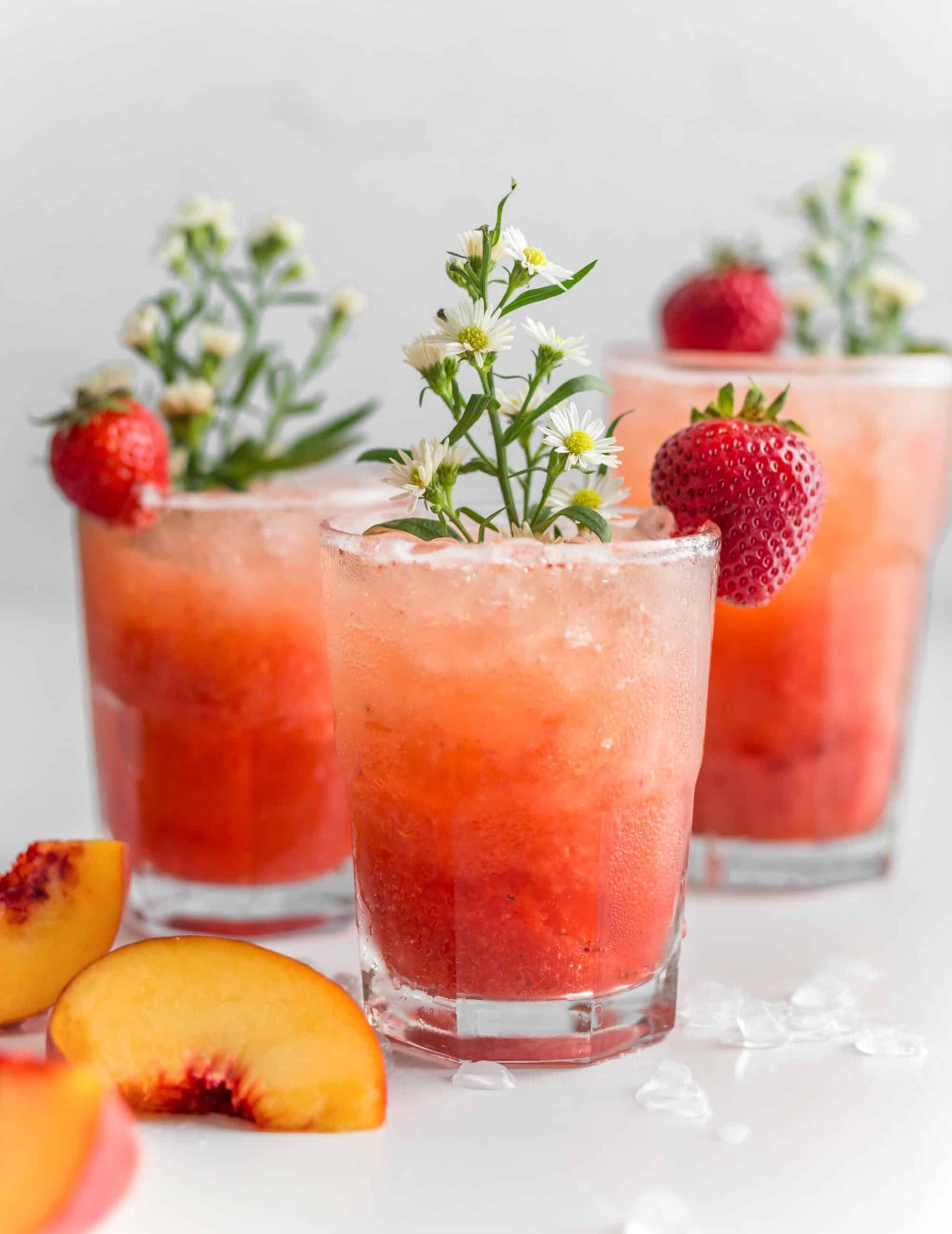 Bubbly Strawberry Peach Sprirtzer In a Glass Garnished with a Fresh Strawberry