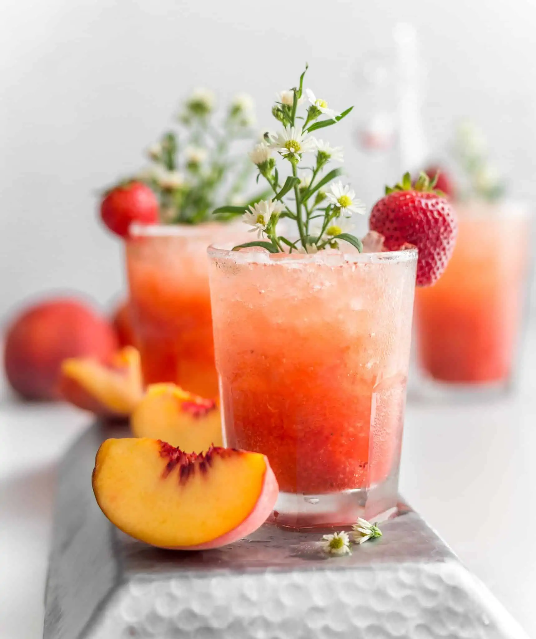 Bubbly Strawberry Peach Sprirtzer Drink Garnished With Chamomile Flowers