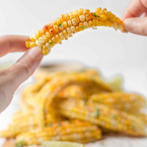 Chipotle Air Fryer Corn Ribs Held Up In Two Hands