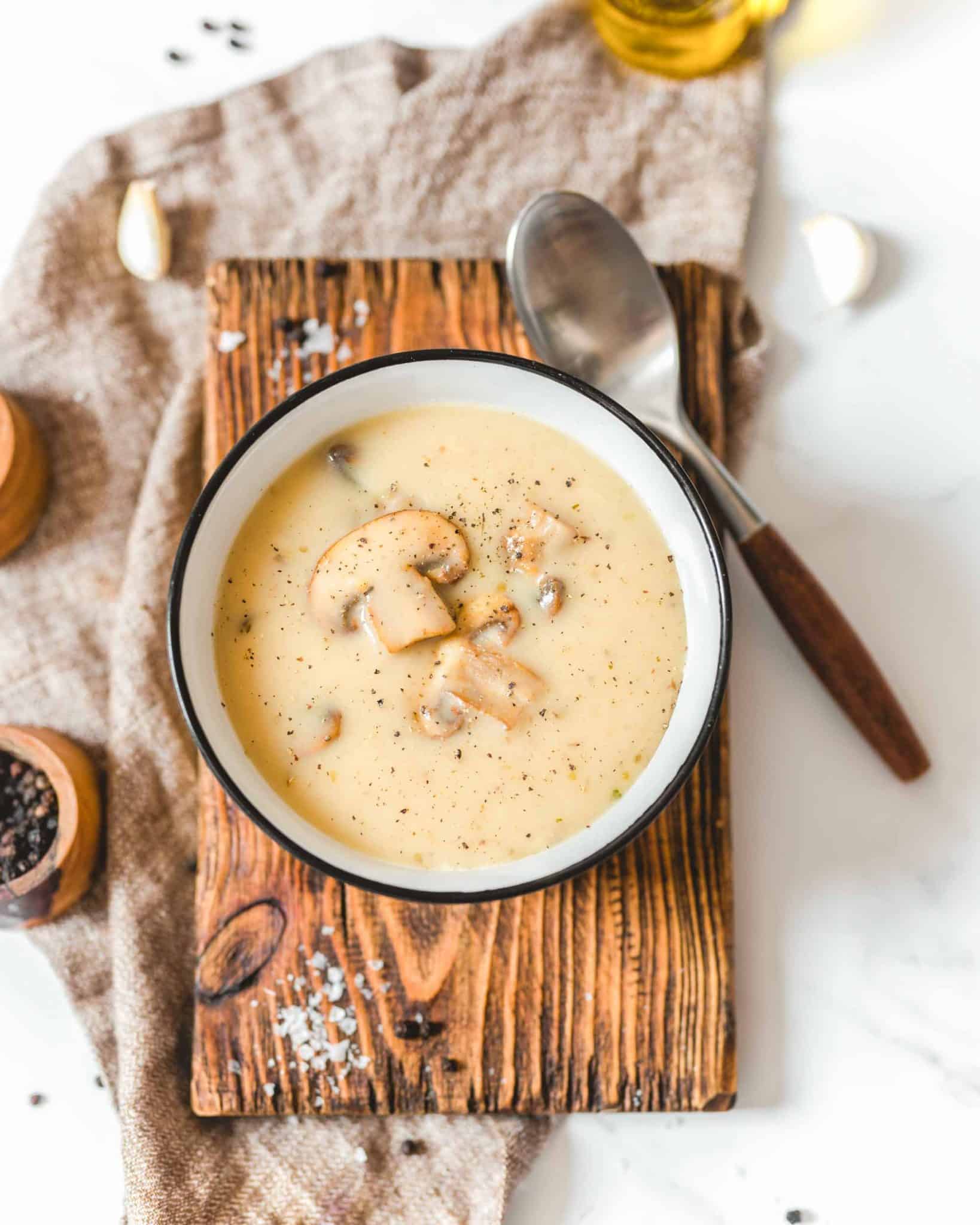 Easy Vegan Cashew Cream of Mushroom Soup In A Bowl on a Cutting Board