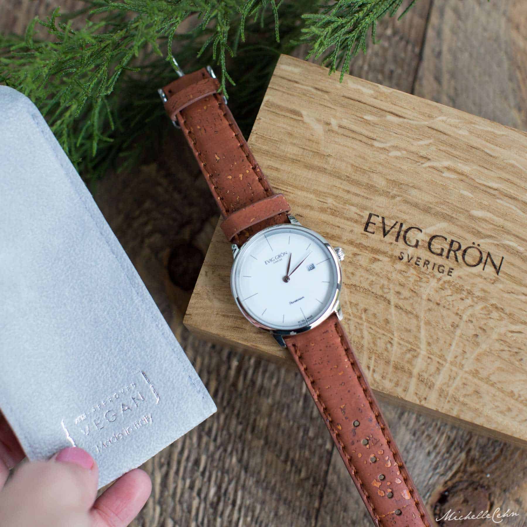 Evig Gron Watch Vegan Watch Brand on a Wooden Watch Box and a faux-suede Watch Case With PETA Approved Vegan Label