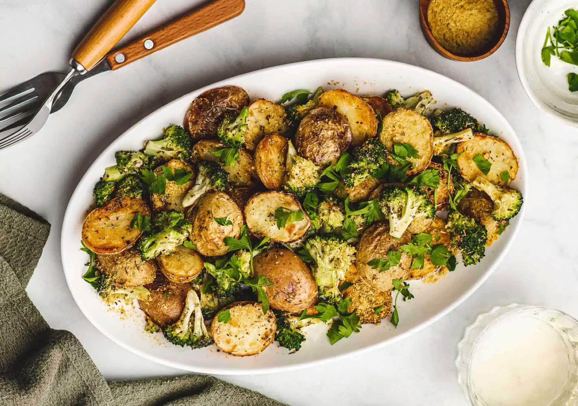 Vegan Cheesy Potatoes With Garlic and Broccoli on a serving platter.