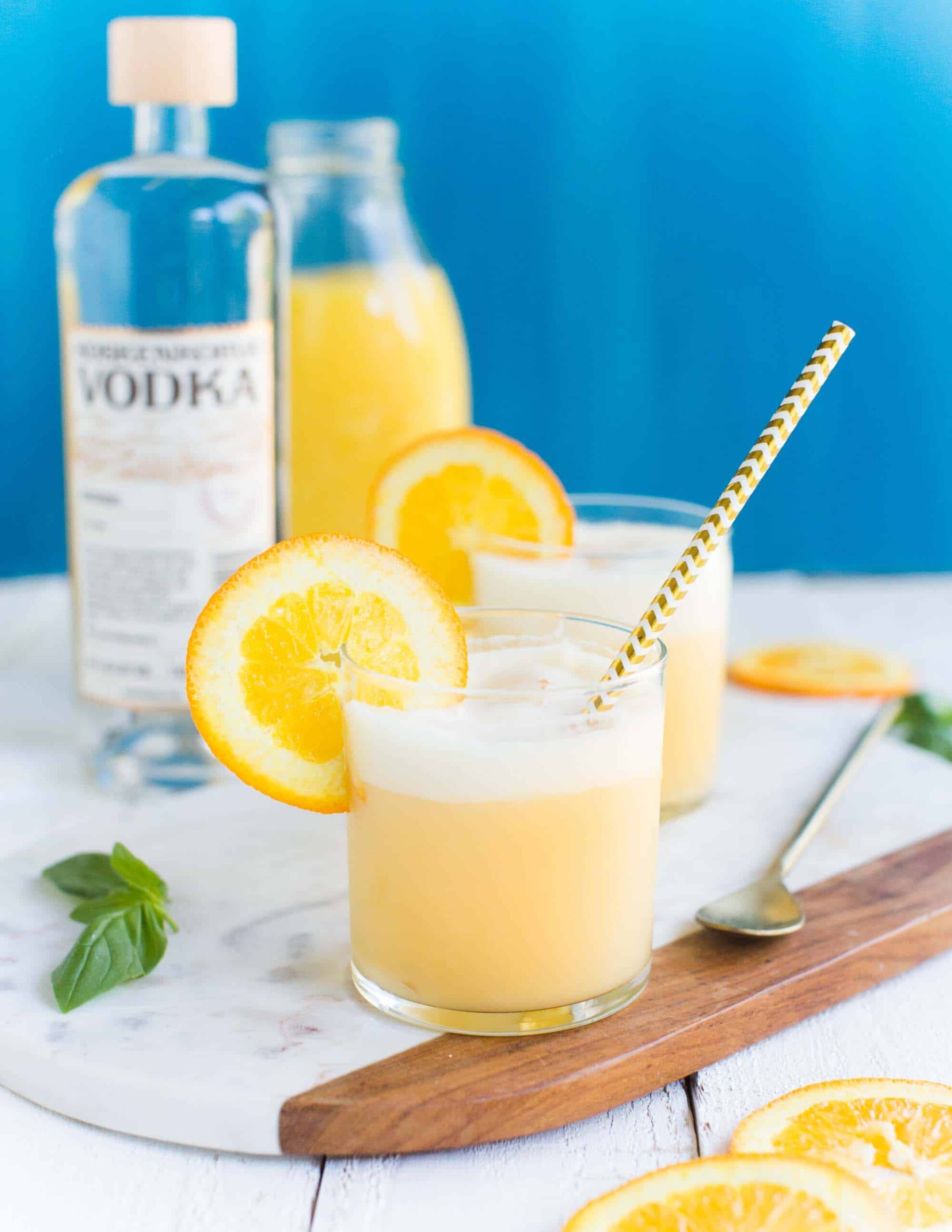 Orange Creamsicle Cocktail in Two Glassed on a Serving Tray with Mint and Orange Slices