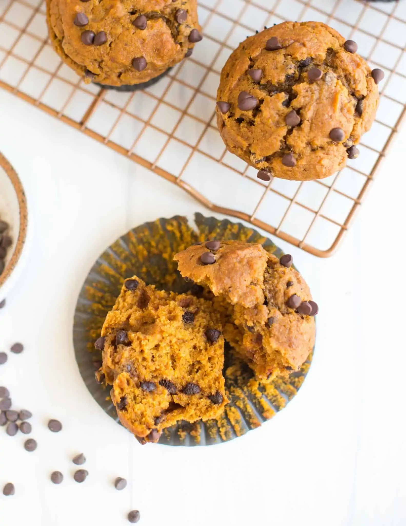 Vegan Pumpkin Muffin Openen on a Cupcake Wrapper by the cooling rack