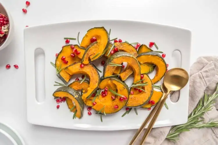 Air Fryer Kabocha Squash With Pomegranite Seeds On A White Plate Vegan Thanksgiving Recipe