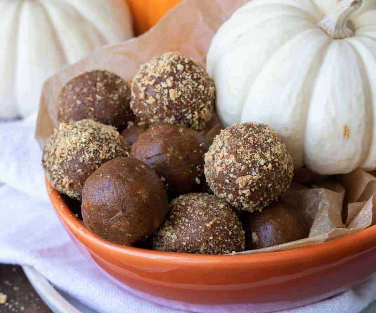 Easy Vegan Pumpkin Pie Protein Balls or Truffles in a bowl with pumpkin decor.