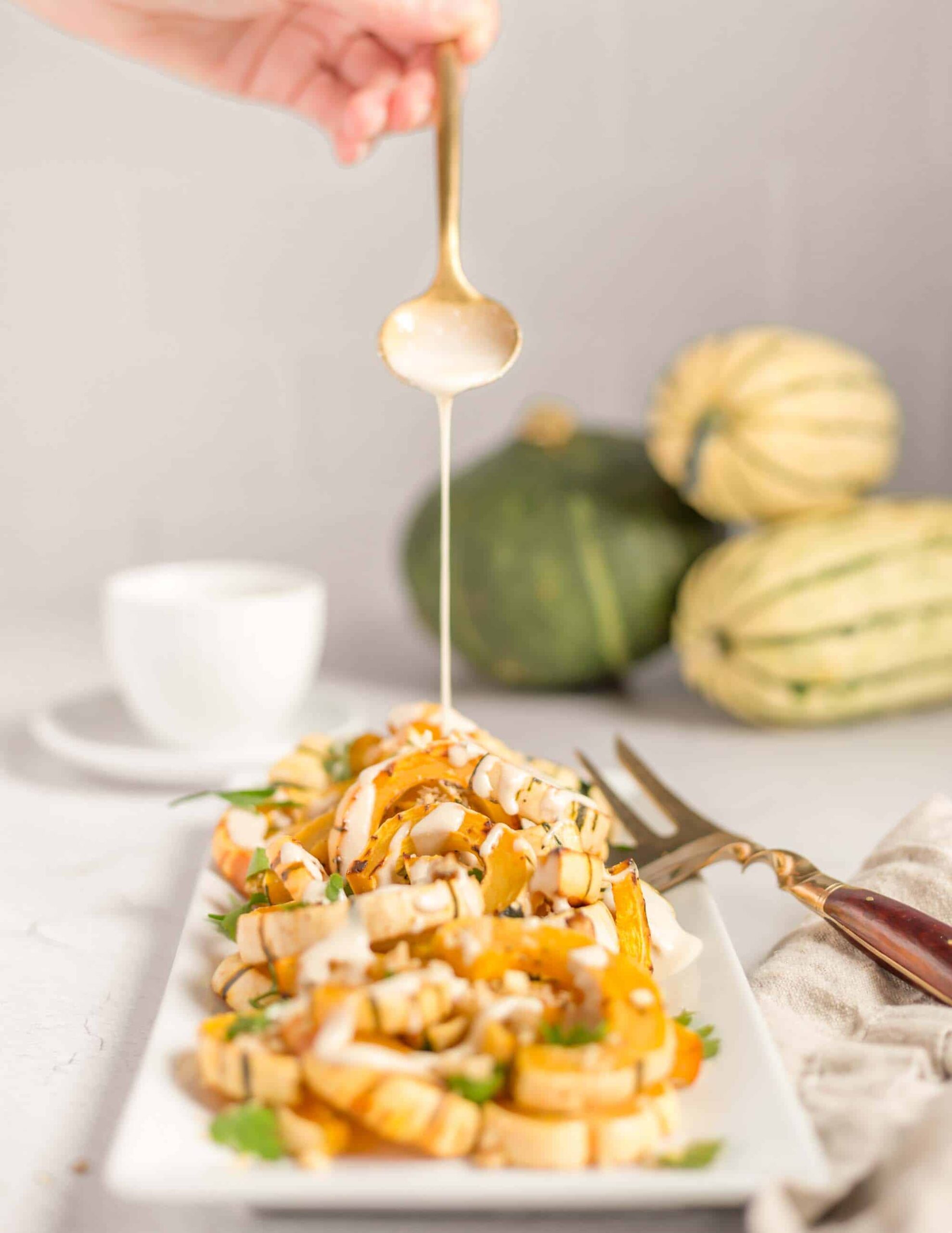 Roasted Delicata Squash drizzled with tahini.