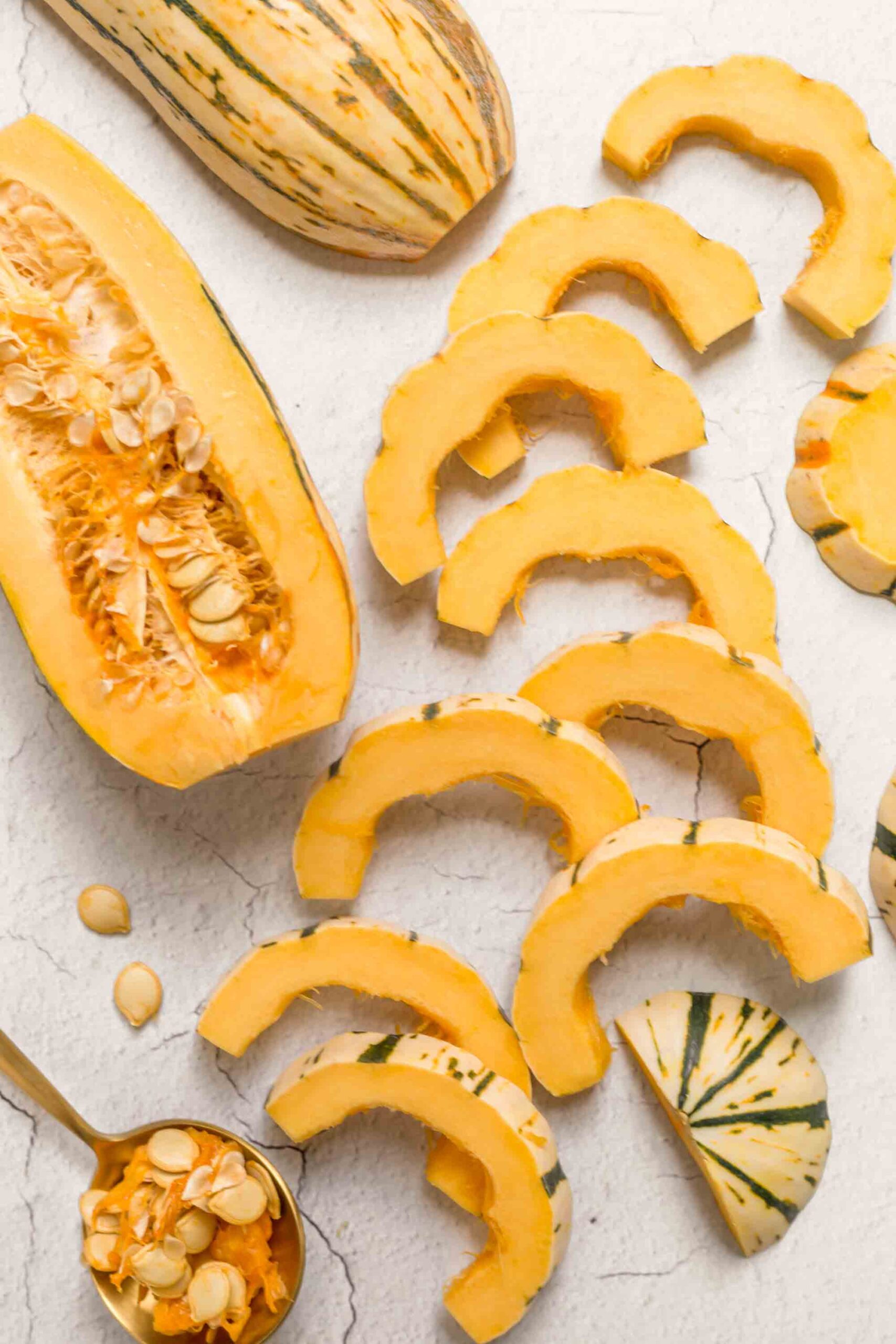 A delicata squash halved and sliced.