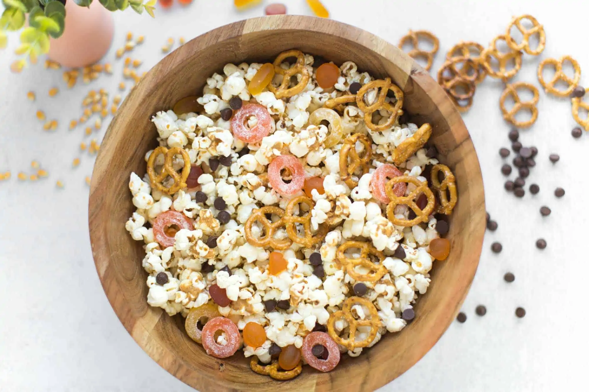 bowl of popcorn with candy, pretzels, and chocolate chips