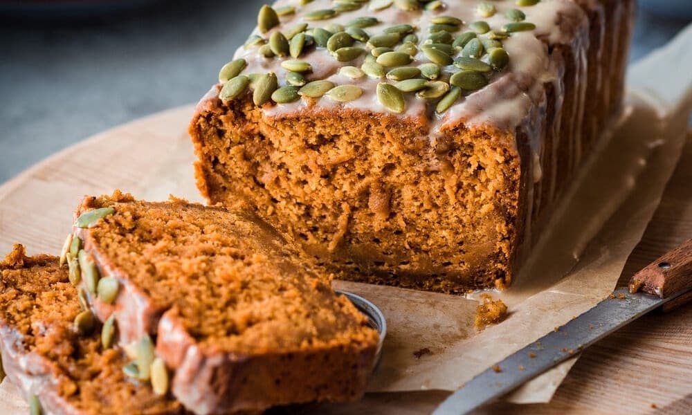 Vegan Pumpkin Spice Bread with Pepitas and glaze on top from Rainbow Plant Life.