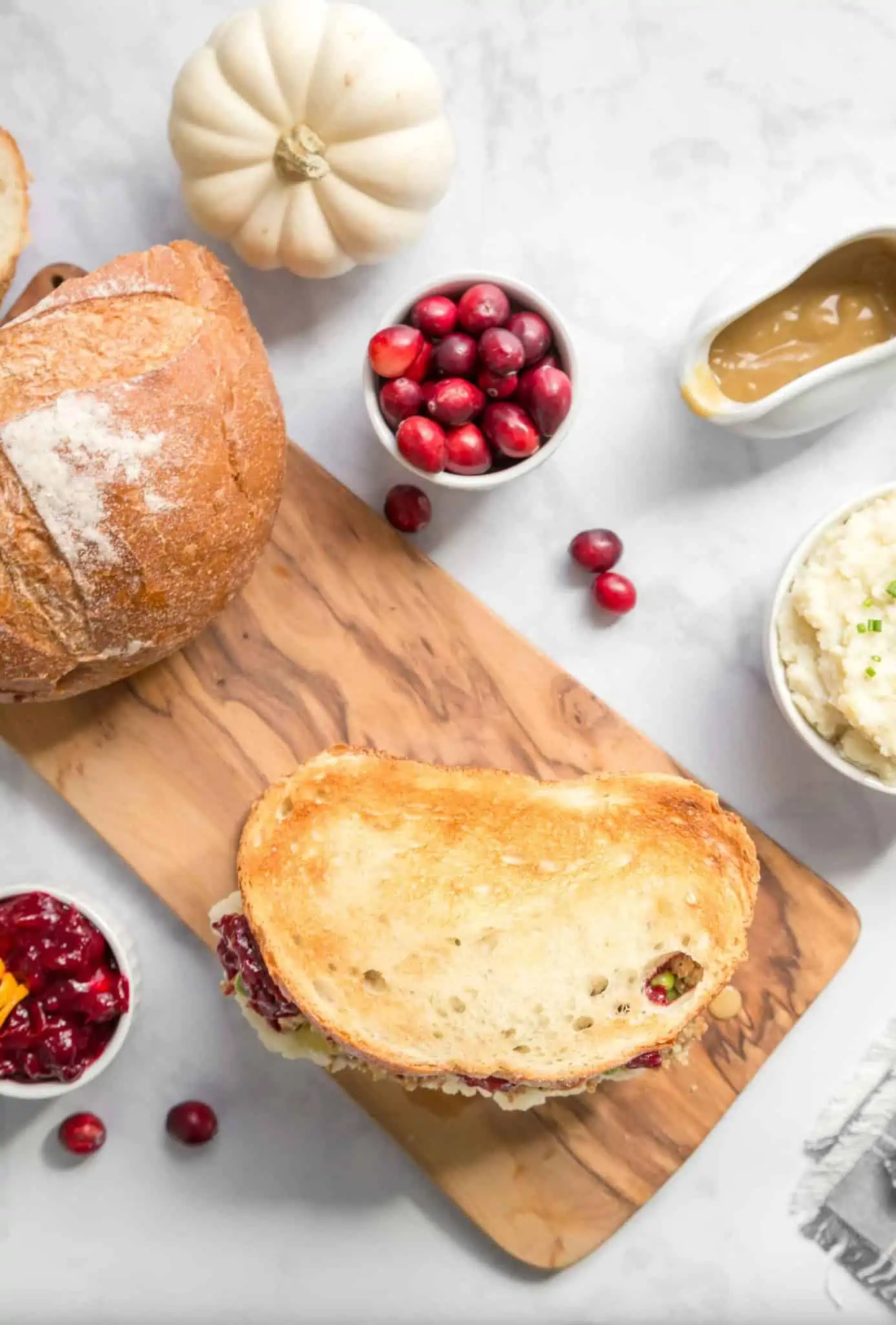 Vegan gravy with a Thanksgiving sandwich and a side of cranberries. 