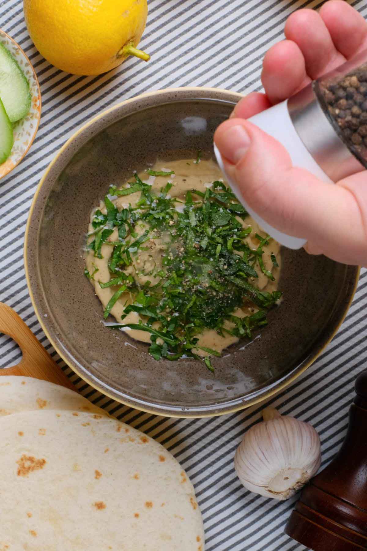 Tahini in a bowl with chopped parsley.