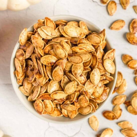 A top-down shot of a bowl of pumpkin seeds.