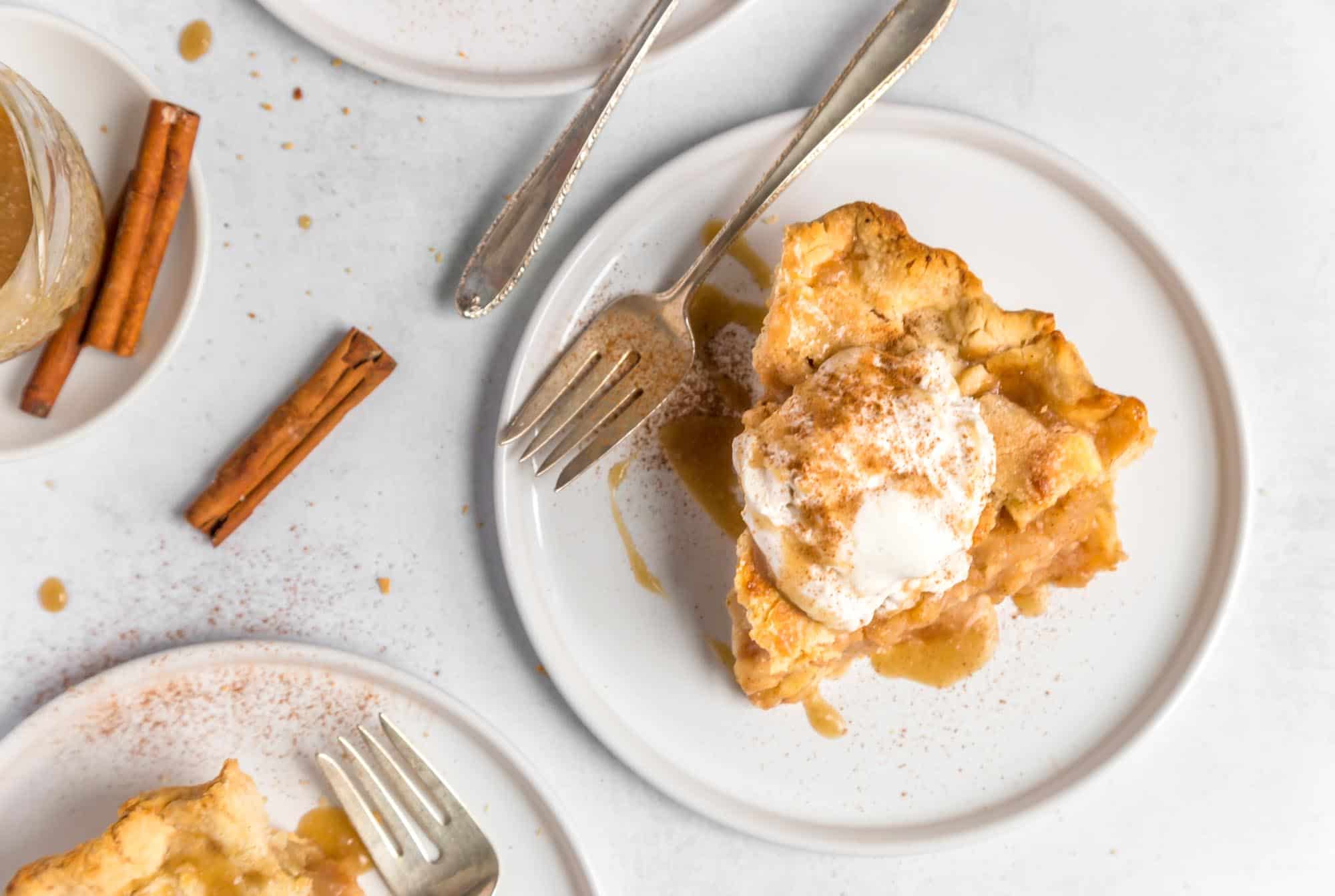 Best Vegan Apple Pie on a Plate With Vanilla Ice Cream And A Rustic Fork