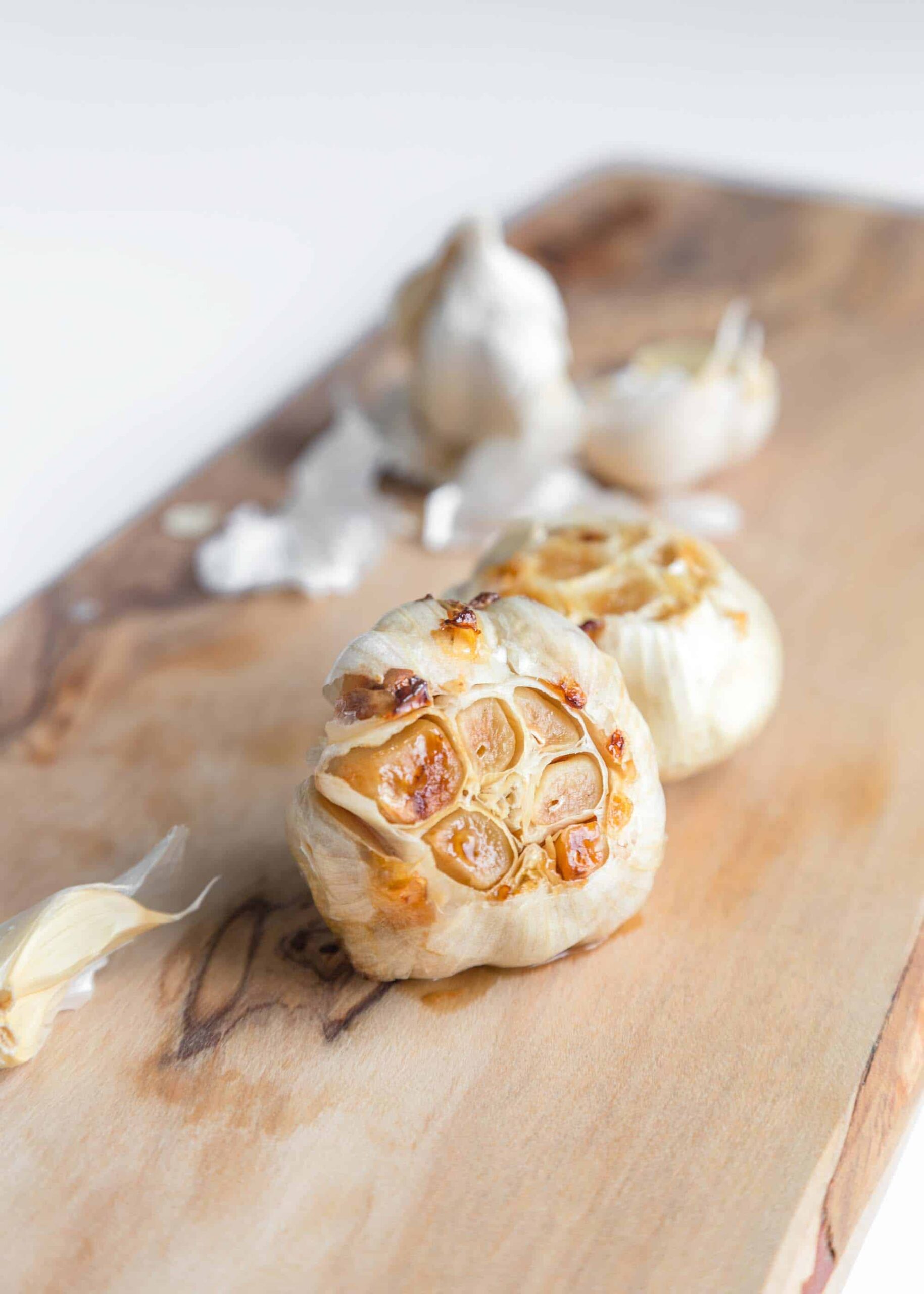 A Head of Roasted Garlic on a Cutting Board