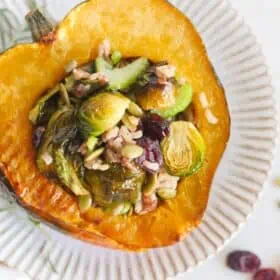 Vegan Stuffed Acorn Squash Thanksgiving Recipe With Wild Rice Pilaf Brussels Sprouts and Cranberries