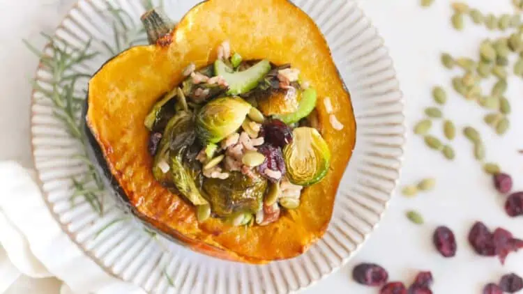 Vegan Stuffed Acorn Squash Thanksgiving Recipe With Wild Rice Pilaf Brussels Sprouts and Cranberries