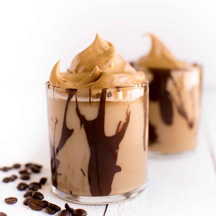 Dalgona coffee cocktail in glasses with a drizzle of chocolate liquor.
