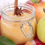 fall homemade apple sauce in a canning jar with cinnamon and fresh apples