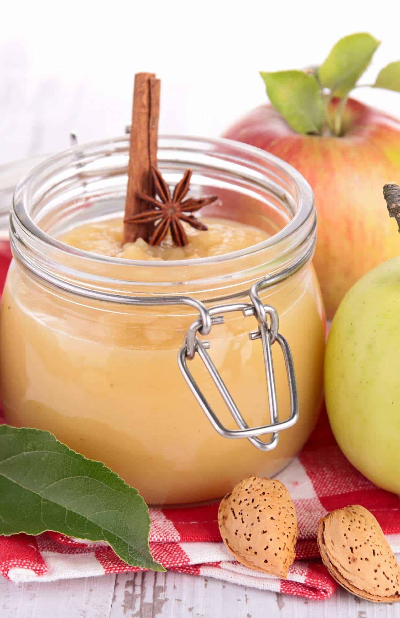 fall homemade apple sauce in a canning jar with cinnamon and fresh apples