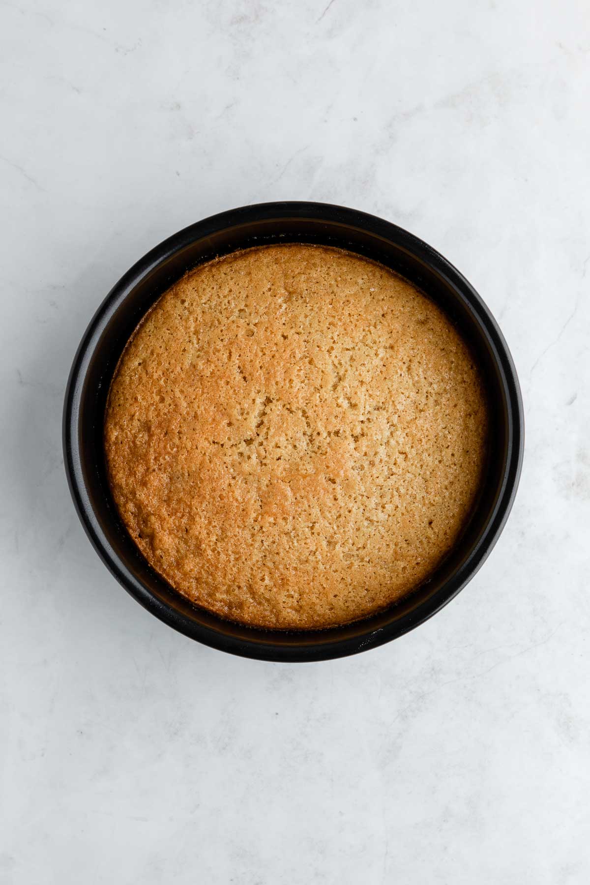 Baked vegan cake in a cake pan.
