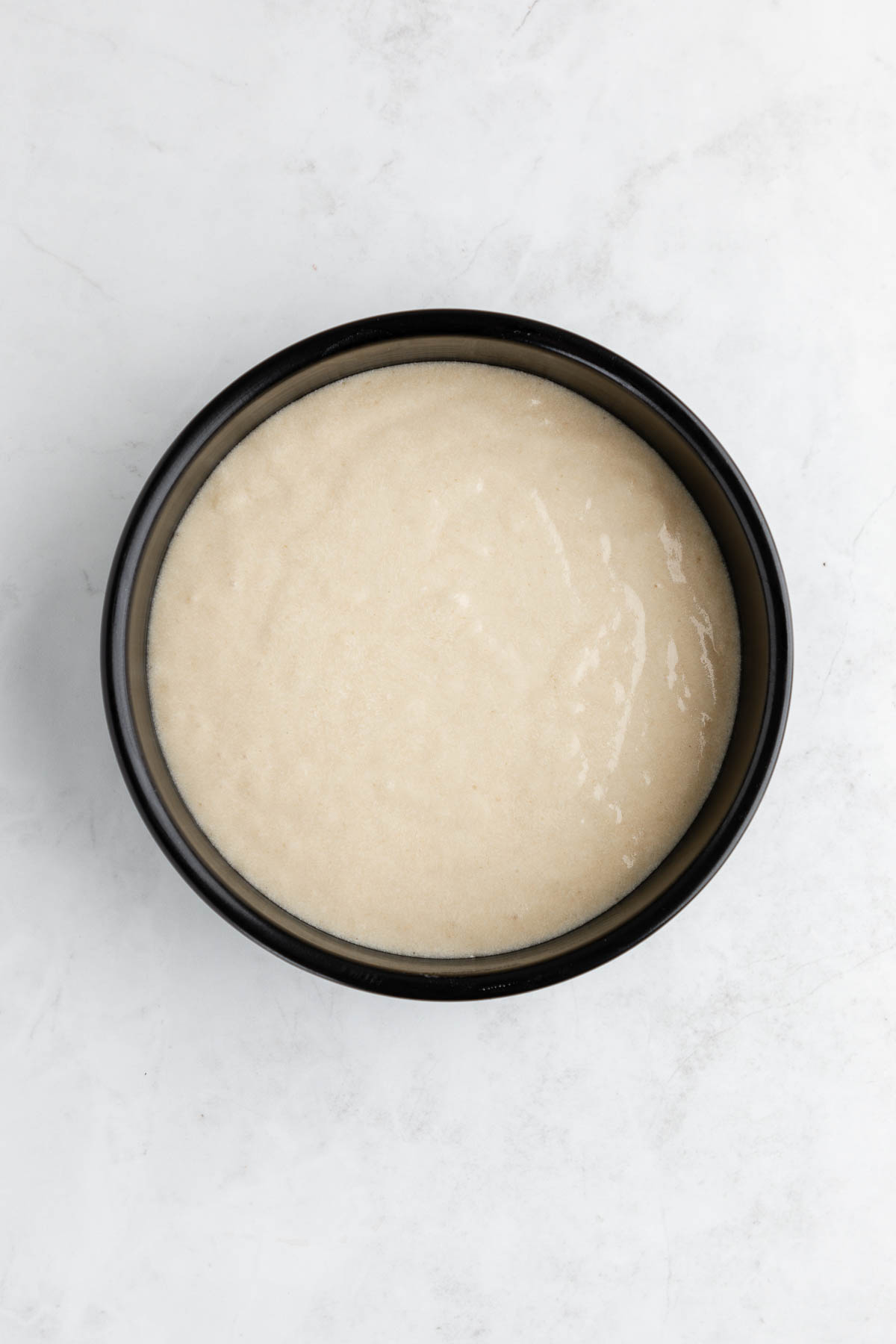Vegan cake batter in a cake pan.