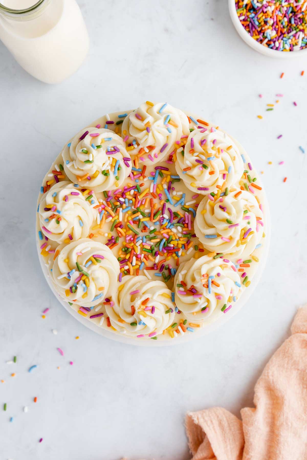 A frosted vegan birthday cake with sprinkles.