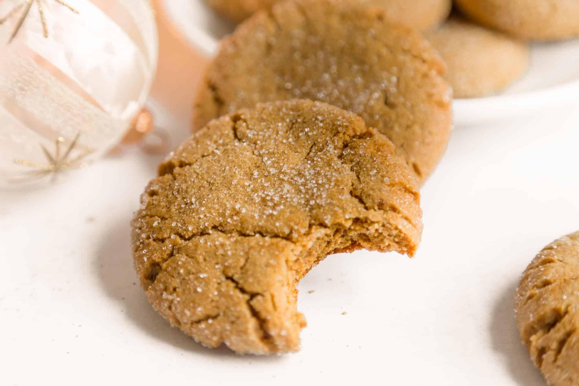 Chewy Vegan Gingersnap Cookie With a Bite Taken on a Table
