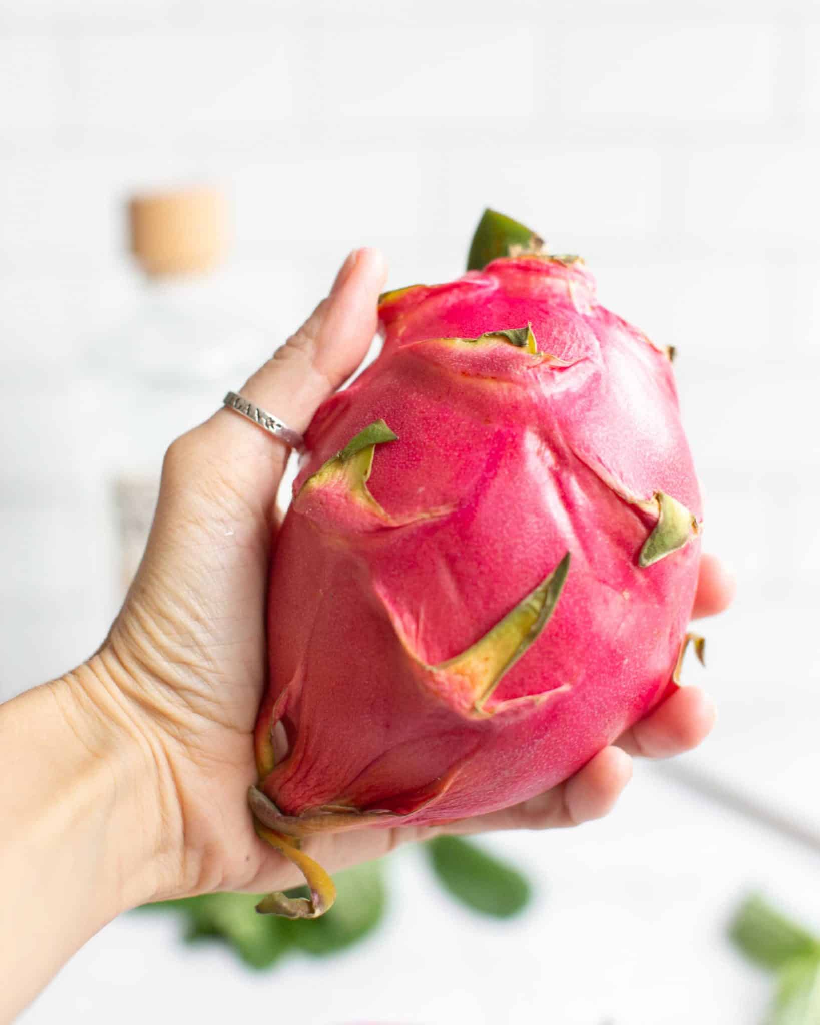 Holding out a Dragonfruit Pink Skin