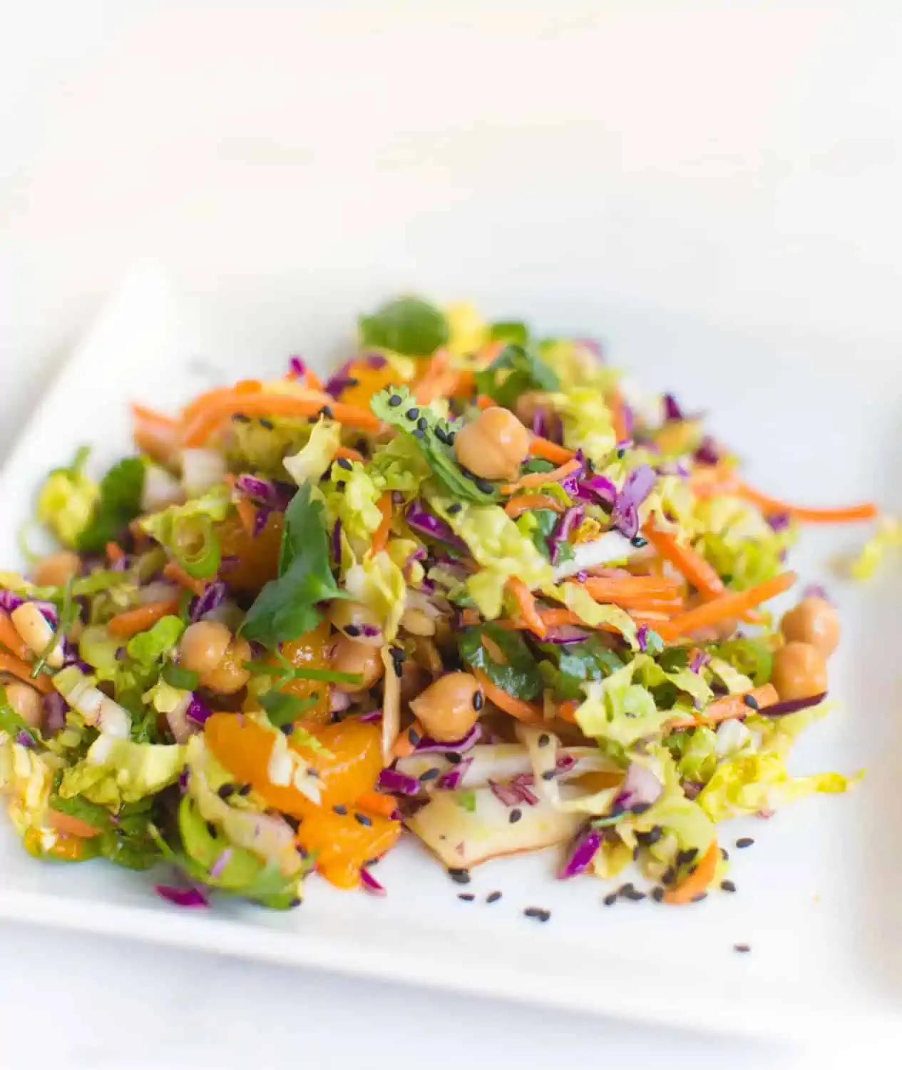 Gluten-free vegan side dish with cabbage, chickpeas, almonds, mandarin oranges, and more.
