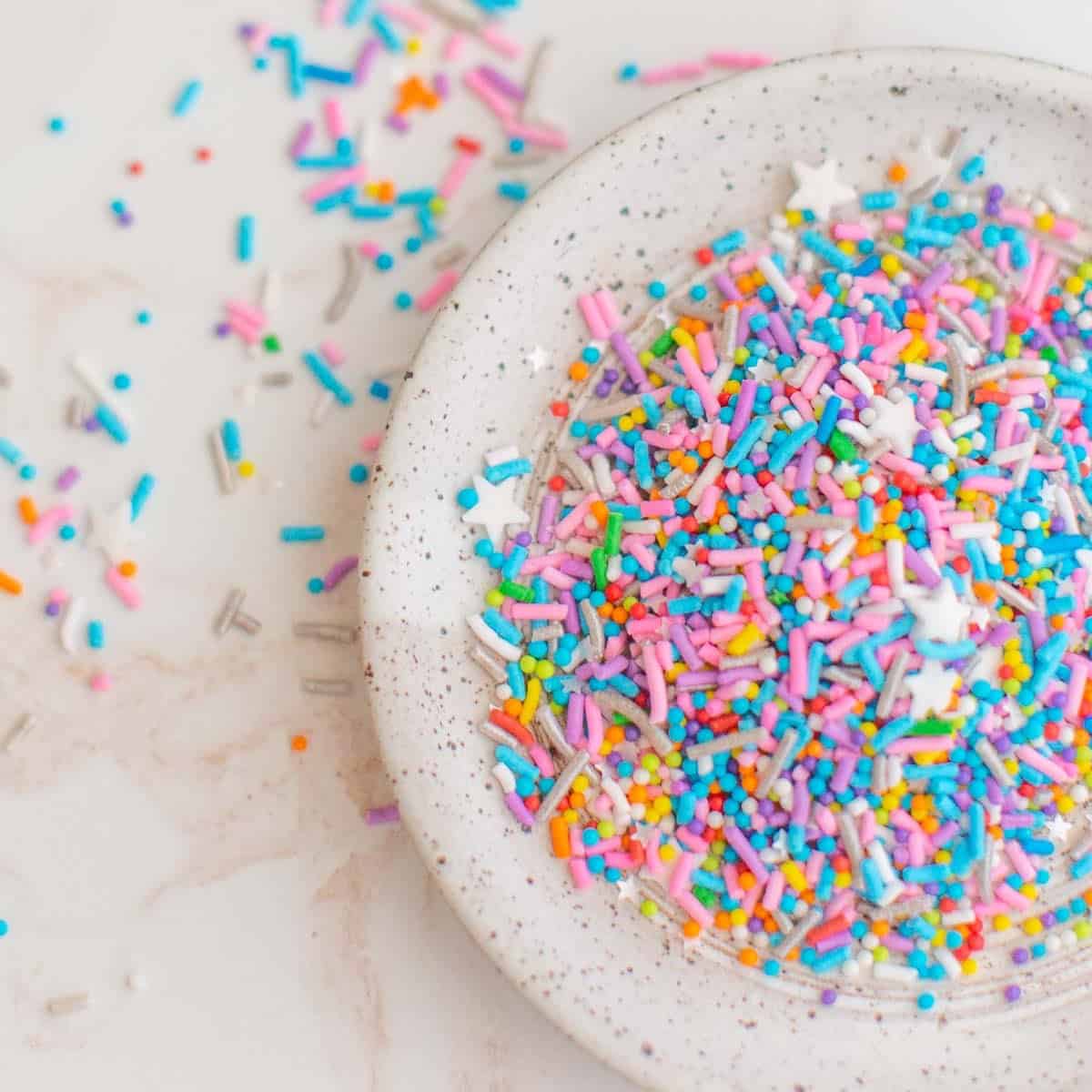 A bowl of vegan rainbow sprinkles with stars.