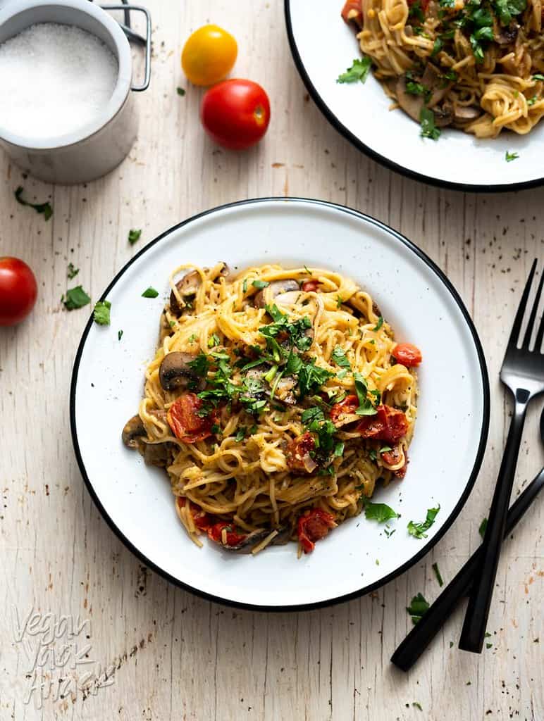 vegan spaghetti with mushrooms, tomatoes, and herbs