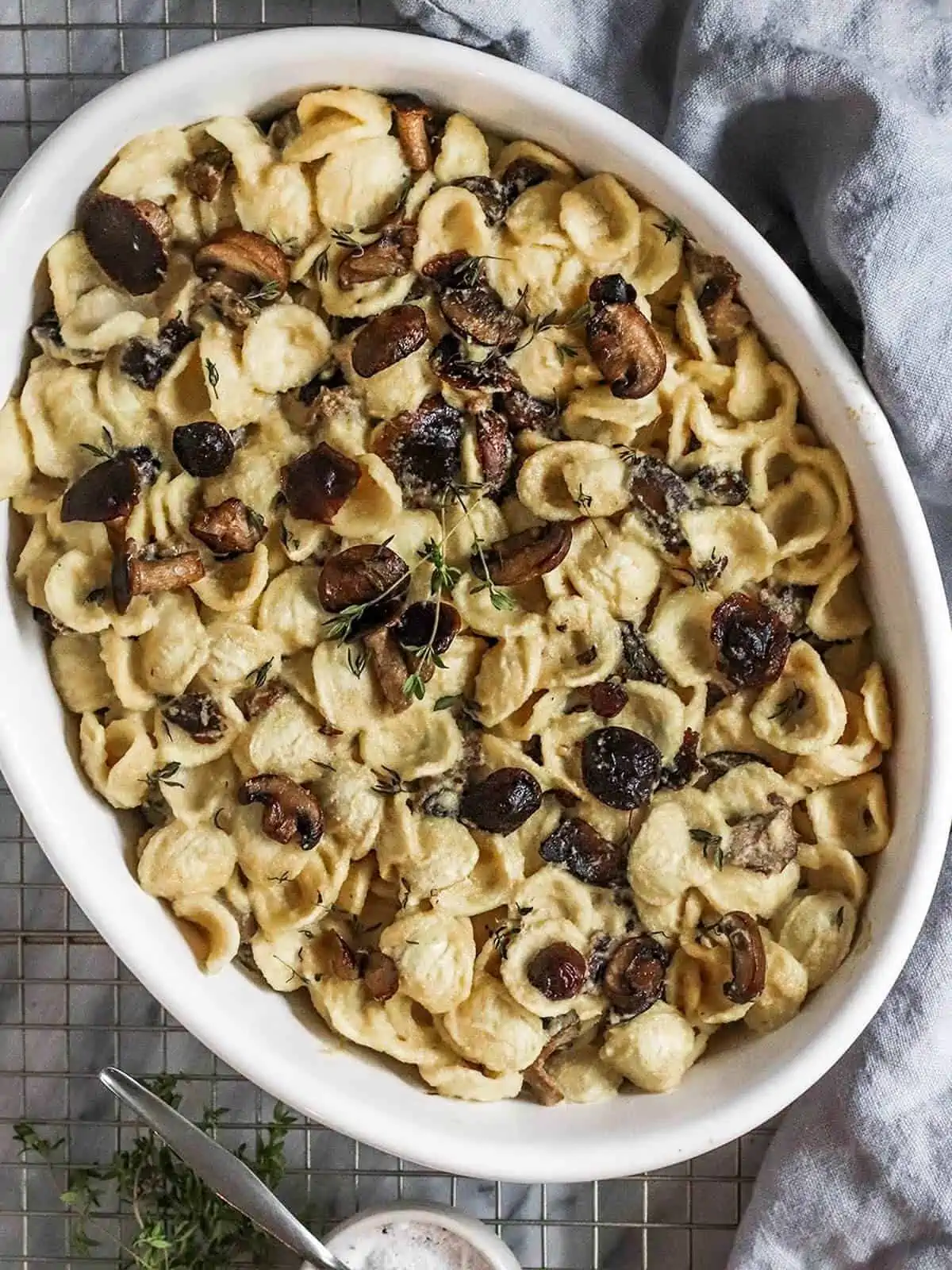 vegan truffle pasta with mushrooms in a round casserole dish