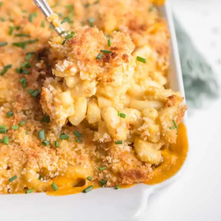 Baked vegan mac and cheese in a white casserole dish.